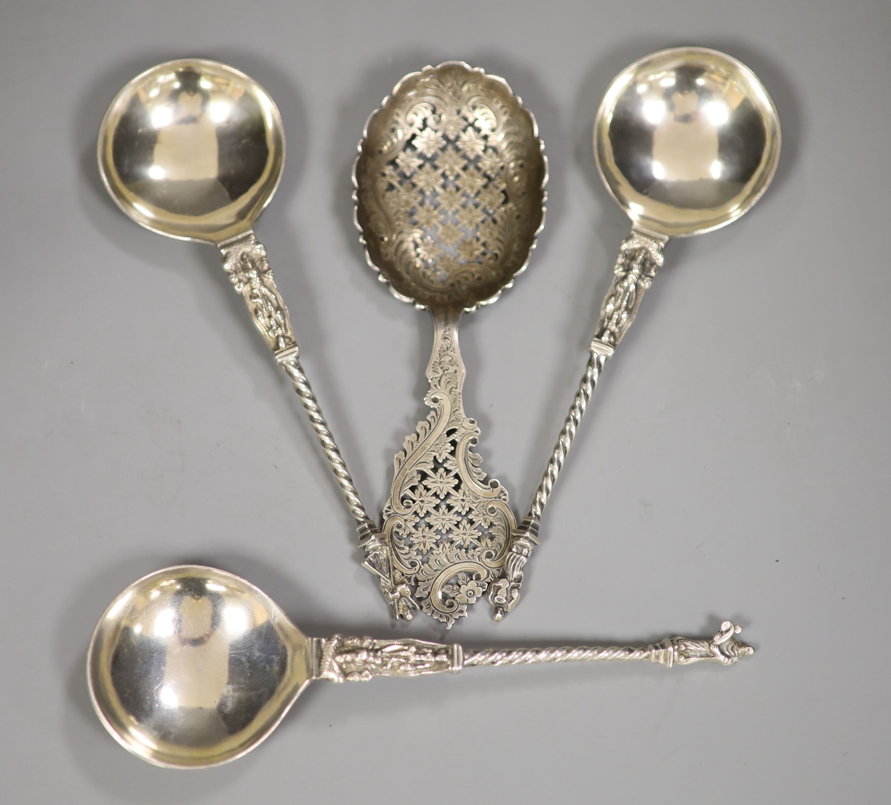 A late Victorian ornate pierced silver sifter spoon, Sheffield, 1898, 17.1cm and three continental apostle spoons